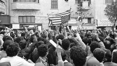 Iranian students hold raised fists in the air and set fire to an American flag on Monday, November 5, 1979 a day after the occupation of the American Embassy in Tehran. AP
