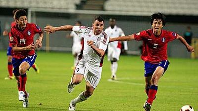 Al Jazira’s Bare, centre, vies for the ball with Jung-soo Lee, left, and Tae-hwi Kwak, of South Korea.