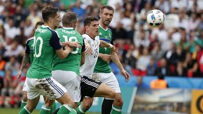 Germany's Mario Gomez, 2nd from right, eyes the ball during the Euro 2016 Group C soccer match between Northern Ireland and Germany at the Parc des Princes stadium in Paris, France, Tuesday, June 21, 2016. (AP Photo/Francois Mori)