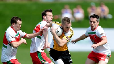 Team Middle East 1, in yellow, plays against team Canada 2 in the Gaelic football tournament during the GAA World Games at Zayed Sports City in Abu Dhabi on March 6, 2015. Christopher Pike / The National