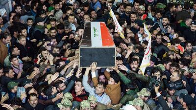 Mourners carry the coffin of slain Iraqi paramilitary chief Abu Mahdi al-Muhandis towards the Imam Ali Shrine in the shrine city of Najaf in central Iraq during a funeral procession. AFP
