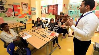 Mohammed El Maghrabi, the head of the Arabic department (right) teaching expat parents basic Arabic at Gems World Academy in Dubai. Satish Kumar / The National