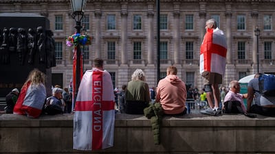 Unite The Kingdom protesters draped in the flag of St George in London. Getty Images