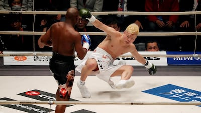 Floyd Mayweather Jr, left, knocks down Tenshin Nasukawa in the first round. Issei Kato / Reuters