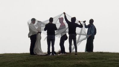 Members of staff of a Taiwanese wedding company help out with a couple’s photo shoot at the Yang Ming Shan National Park in Taipei. Sam Yeh / AFP Photo