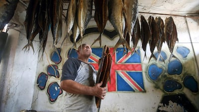 A man examines masmouta hanging from a ceiling, ready to be sold at market for Eid. Reuters