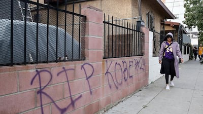 A fan writes a message in front of their house in memory of former Los Angeles Lakers guard Kobe Bryant in Los Angeles, California. EPA
