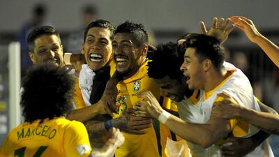Midfielder Paulinho, centre, is enjoying a return to form as a Brazil international. Dante Fernandez / AFP
