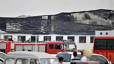 Rescue workers and fire trucks are seen outside a site of a fire, at a poultry slaughterhouse in Dehui, Jilin province. Reuters/Xinhua/Wang Haofei