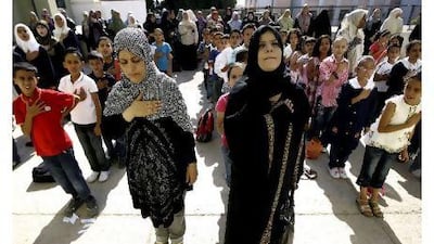 Libyan students and teachers chant the revolution anthem at a school in Tripoli, instead of the oaths of allegiance to Muammar Qaddafi, in one of many changes in Libyan classrooms.