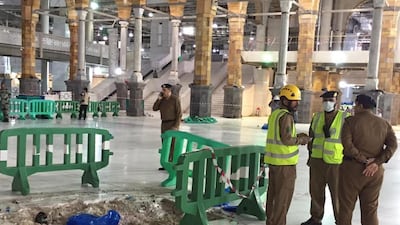 Saudi Arabian civil defence officials inspect the damage after a crane collapsed at the Grand Mosque in Mecca, killing at least 87 people. Saudi Interior Ministry General Directorate of Civil Defense via AP