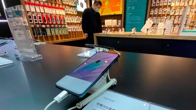A Honor smartphone model on display for sale at an electronic store in Beijing. Chinese tech giant Huawei is selling its budget-price Honor smartphone brand in an effort to rescue the struggling business from damaging US sanctions imposed on its parent company. AP