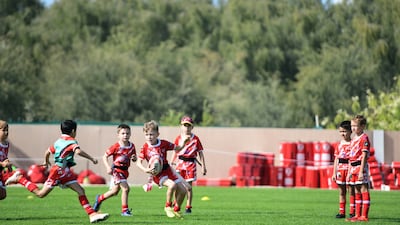 Young boys practice on the field at Dubai Police Academy, Dubai.