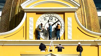 Workers restore the Clock of the South of the Legislative Palace to conventional numbering and direction, in La Paz, Bolivia. Since 2014, the clock has operated in reverse, with its hands turning counter-clockwise and the face displaying inverted numerals, to affirm the Andean nation's 'southernness'. EPA