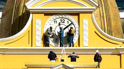 Workers return the 'Clock of the South' at Bolivia's Legislative Palace to the conventional clockwise direction. Since 2014, the clock turned counter-clockwise, with its face displaying inverted numerals. EPA