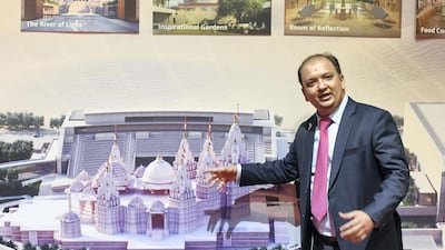 Pranav Desai shows the floor plan for the temple on-site. Khushnum Bhandari for The National