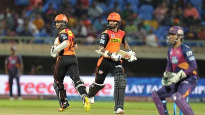 Sunrisers Hyderabad batsman Shikhar Dhawan, right, and Kane Williamson run between the wickets as Rising Pune Supergiants wicketkeeper MS Dhoni, right, looks on. Noah Seelam / AFP