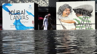 Visitors walk past the art works displayed at the Dubai 3D Art Festival at the Dubai City Walk in Dubai. Satish Kumar / The National