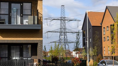An electricity pylon next to a new residential housing development in Ebbsfleet, UK