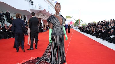 Jodie Turner-Smith in a black and silver sequinned Gucci dress with lime green satin gloves. Getty Images