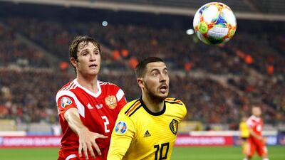 Hazard in action with Russia's Mario Fernandes. Reuters