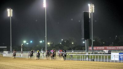 Jockeys on track at the Arabian Adventures Maiden 1,400m dirt race at Meydan. Reem Mohammed / The National