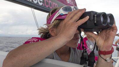 Abby Ehler of Team SCA watches through binoculars out at a rival yacht during the first leg of the Volvo Ocean Race, in the middle of the Atlantic. Corinna Halloran / Team SCA / Volvo Ocean Race / October 21, 2014