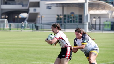 Josie Simm of Abu Dhabi Bats is tackled.