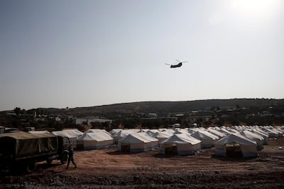 A Greek army's helicopter carrying European Council President Charles Michel flies over the temporary camp where refugees and migrants from the destroyed Moria camp will be accommodated, on the island of Lesbos, Greece, September 15, 2020. Reuters