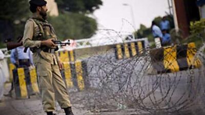 A soldier of Pakistan's paramilitary force stands guard at a checkpoint in Islamabad, Pakistan, on Oct 2 2008. The UN ordered children of its international staff to leave the Pakistani capital and other areas it considered unsafe, following the bombing of the Marriott Hotel.