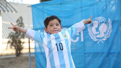 Murtaza Ahmadi, the Afghan boy who was pictured wearing a Messi shirt made out of a plastic bag, sports his new shirt signed by the Argentina and Barcelona player. Courtesy Unicef