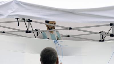 A worker prepares to unveil a birthday cake including a statue depicting Lionel Messi. AFP