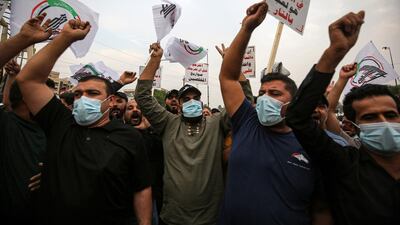 Supporters of the Iran-backed Hashd Al Shaabi (Popular Mobilisation) paramilitary forces chant slogans during a demonstration outside the entrance to the Iraqi capital Baghdad’s highly fortified Green Zone on November 7, 2020, demanding the departure of remaining US forces from Iraq. AFP