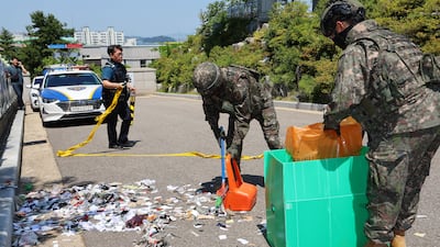 Military personnel clear the rubbish from balloons sent by North Korea in Incheon, west of Seoul. EPA