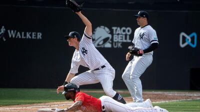 Boston Red Sox centre fielder Jackie Bradley Jr. slides in on a fielding error by New York Yankees second baseman Gleyber Torres. Reuters