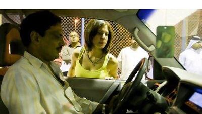 Dana Shaheen, 21, an American, looks at what might be her first car.