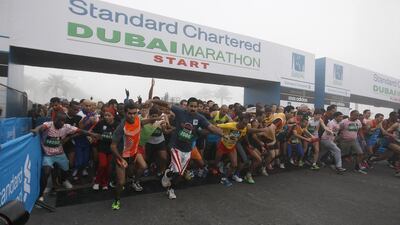 Under an early-morning fog, runners start the Dubai Marathon 10km race last year. More than 20,000 are expected to compete in three different categories tomorrow. Mike Young / The National