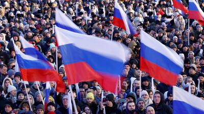 Crowds hold Russian flags at the rally and pop concert on Red Square on Monday. Reuters