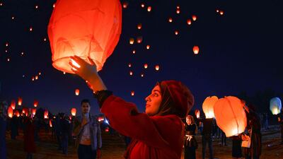 Iraqis in the holy shrine city of Najaf launch rice paper hot air balloons to show their solidarity with the ongoing anti-government protests across the country. AFP
