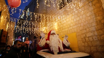 A Palestinian dressed as Santa Claus takes part in the celebrations. Reuters