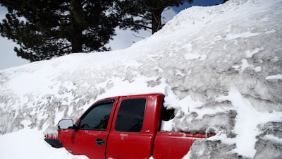 A car is struck in snow after a recent storm brought 30 inches of snow in less than 24 hours earlier in the week, in Mammoth Lakes, California, USA, 03 April 2023. California's Mammoth Mountain has shattered its all-time snowfall record earlier this week, with more than 700 inches of snow so far this season, as reported by UC Berkeley Snow Lab. The state's snowpack has also reached an all-time high due to 17 atmospheric rivers that have been hitting the state since December, after years of drought. EPA / CAROLINE BREHMAN