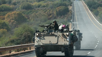 Israeli soldiers drive APCs near the border with Lebanon on Saturday. Tensions remain high at the border between the two countries. EPA