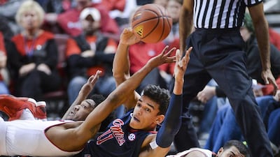 Mississippi’s Sebastian Saiz tries to pass the ball to a teammate after Bradley’s Antoine Pittman, left, and Dwayne Lautier-Ogunleye fell to the floor in pursuit of a loose ball during an NCAA college basketball game in Peoria, Illinois, on November 28, 2015. Mississippi won 67-54. Ron Johnson / Journal Star via AP