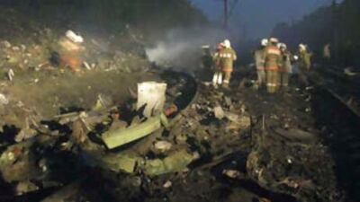 Firemen work at the site where a Russian airliner crashed next to a railway tack outside the Ural city of Perm on Sept 14 2008.
