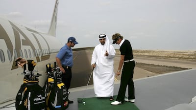 Ian Poulter of England and Paul Casey of England give an impromptu golf lesson to Etihad passenger Khalie Al Shamsi of the UAE as they signal take-off for their Ryder Cup campaigns as they hit drives from the wing of an Etihad Boeing 767 on the runway at the Abu Dhabi International Airport on January 18, 2006 in Abu Dhabi, United Arab Emirates. Poulter outdrove Casey from the wing with an unofficial drive of 696 yards against Casey's best of 689 yards. The drive was the longest ever recorded in the Middle East and Asia and was an opening preview for the Etihad co-sponsored Abu Dhabi Golf Championship on the National Course at Abu Dhabi Golf Club. David Cannon / Getty Images for Etihad Airways