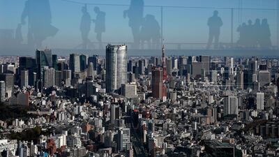 Visitors are reflected as they watch central Tokyo skyline in Tokyo, Japan. EPA