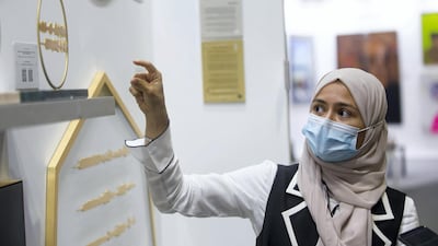 Artist Sara Alharbali with her artworks at the World Art Dubai. Leslie Pableo / The National