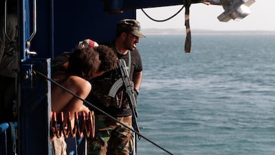 A fighter keeps watch on the deck of the Galaxy Leader cargo ship, seized by the Houthis near Al Salif port on the Red Sea in the province of Hodeidah, Yemen. EPA