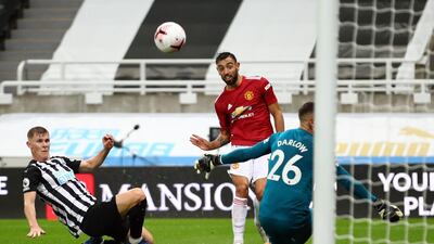 Manchester United's Portuguese midfielder Bruno Fernandes (C) scores their second goal during the English Premier League football match between Newcastle United and Manchester United at St James' Park in Newcastle-upon-Tyne, north east England on October 17, 2020. RESTRICTED TO EDITORIAL USE. No use with unauthorized audio, video, data, fixture lists, club/league logos or 'live' services. Online in-match use limited to 120 images. An additional 40 images may be used in extra time. No video emulation. Social media in-match use limited to 120 images. An additional 40 images may be used in extra time. No use in betting publications, games or single club/league/player publications. / AFP / POOL / Alex Pantling / RESTRICTED TO EDITORIAL USE. No use with unauthorized audio, video, data, fixture lists, club/league logos or 'live' services. Online in-match use limited to 120 images. An additional 40 images may be used in extra time. No video emulation. Social media in-match use limited to 120 images. An additional 40 images may be used in extra time. No use in betting publications, games or single club/league/player publications.