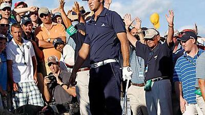 Dustin Johnson stands in a bunker on the 18th hole during his final round of the US PGA Championship. The American was penalised for grounding his club in the bunker, ending his hopes of victory.